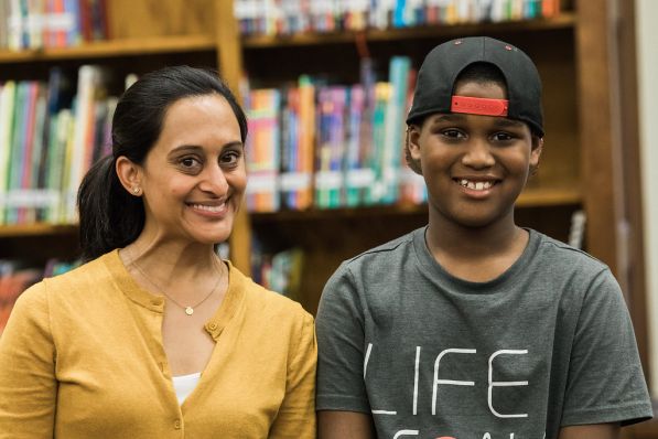Tutor and older student standing side by side