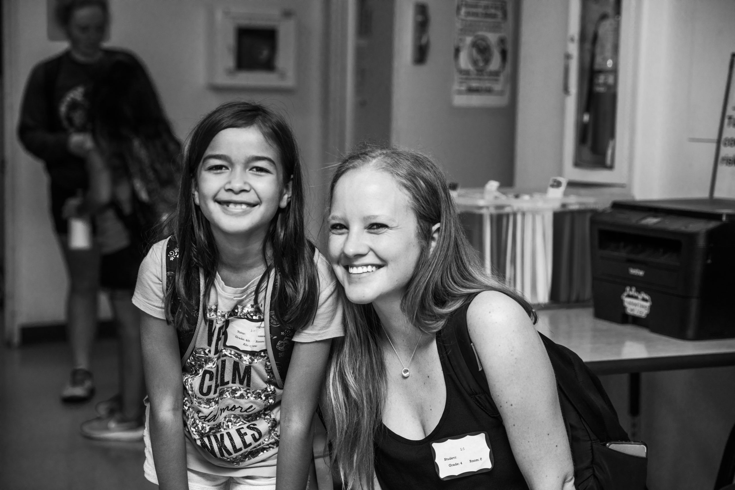 volunteer tutoring student with glasses