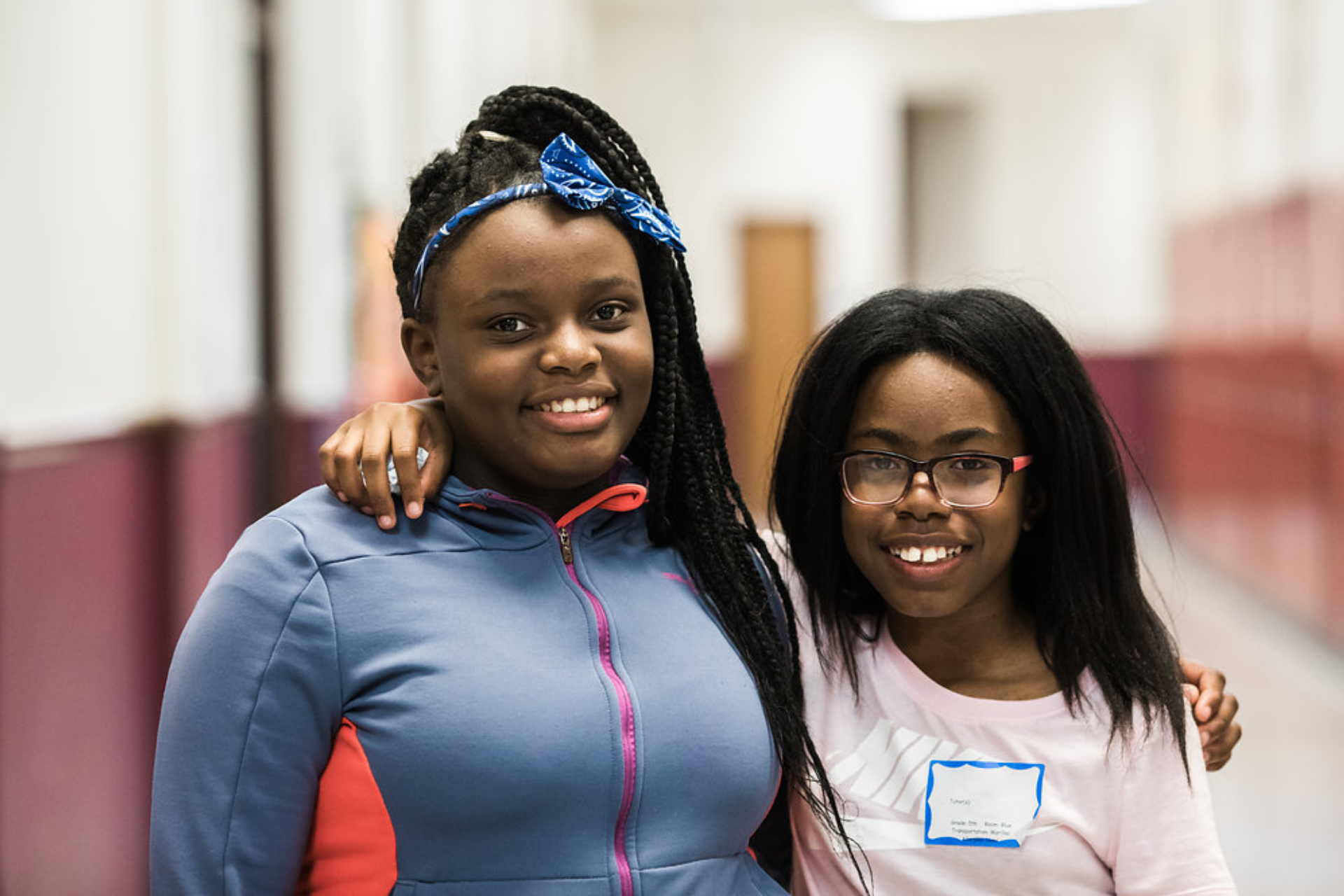 volunteer teaching student in pink shirt